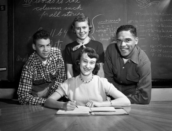 Portrait of some of the committee chairmen for the 1954 Junior Prom at Central High School. Seated in the foreground is Judy Jensen. Behind her are Dick Day, Lillian Krajnak, and Lorenzo Doss.