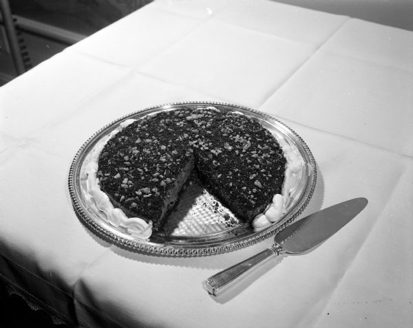 Ozark Black Walnut Chocolate Torte, the first entry in the Treats and Tricks column in the <i>Wisconsin State Journal</I>, was submitted by Mary Ramirez. Neighbors share recipes and household tips in this new column in the newspaper.