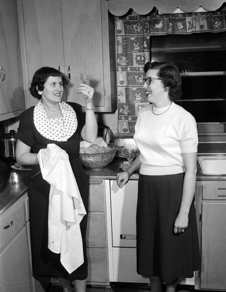 Many cocktail parties preceded the Madison Alumnae Panhellenic Association Benefit Ball.  Elizabeth O'Brien and Faye Mosigin, both of whom are Delta Zeta alumnae, make preparations for a cocktail party.