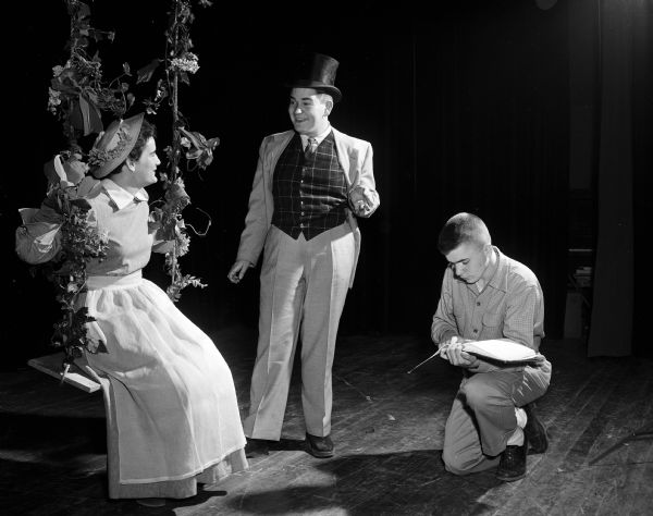 Students at Madison Edgewood High School act out a scene from the play "The Marriage Proposal". Peggy Forster and Michael Kretschman are in the scene and director Bob Spevacek is at the right.