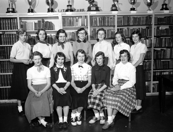 Group portrait of the Y-Teens of Wisconsin High School who will serve as hostesses when parents pay their annual visit to the school. In front, left to right, are: Sandy Treichel, Kay Montie, Elvora Berger, Priscilla Parsons, and Sue Groves. In back, left to right, are: Ellen Herman, Nancy Willett, Lynn Martin, Jane Schlotthauer, Carol Cross, Elizabeth Esser, and Nancy Stein.