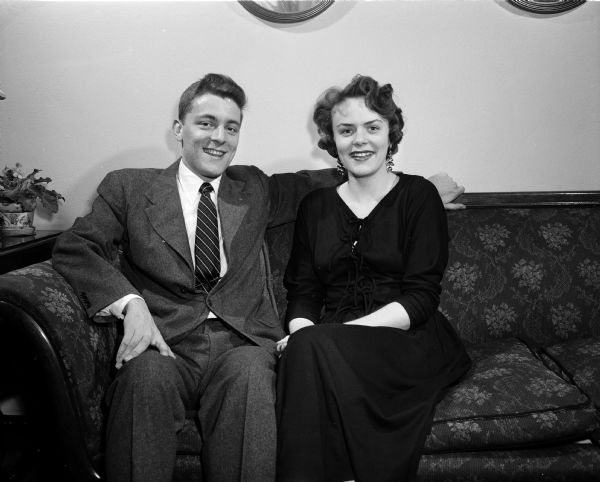 Portrait of William Seibold and Beata Besserdich, an engaged couple, seated on a couch.
