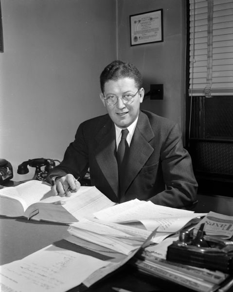 Portrait of labor attorney John Lawton seated at his desk.