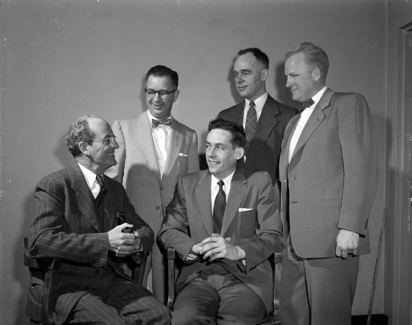 Group portrait of five men who participated in the Wisconsin Canners Raw Products Conference held on the University of Wisconsin campus. Left to right: C.H. Mahoney, New York; Kermit Berger, U.W.; J.E. O' Brien, Columbus: Kenneth Buchholtz, U.W.; and L.G. Holm, U.W.