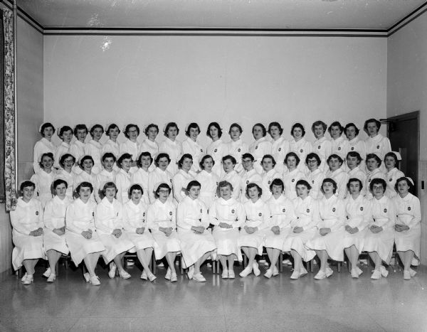 Group portrait of fifty-one St. Mary's Hospital student nurses who received their caps during ceremonies held at St. James Catholic Church.