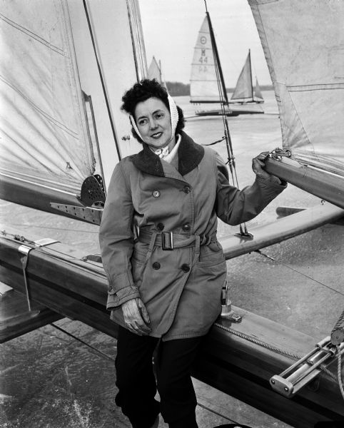Dorothy Braith stands by her husband Norman's iceboat. She was the recipient of ten pints of blood during surgery. She plans to do what she can to help the Red Cross blood drive.