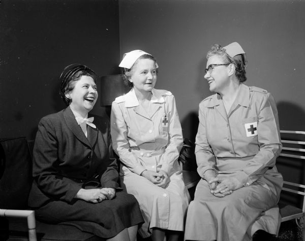 Leaders of the Red Cross Gray Ladies confer. They are, from left: Gladys Erickson, who is taking over as Gray Ladies at the Veterans Hospital; Deborah Sherman, current chair; and Iona Hein, chair of Gray Ladies for Dane County Chapter of the American Red Cross. Gray Ladies is a volunteer organization.