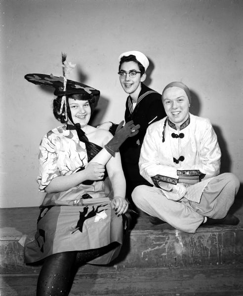Diane Horalek, Harold Peckham, and John Spaeni take part in a masquerade party for East High School seniors on Saturday, February 24, 1954.