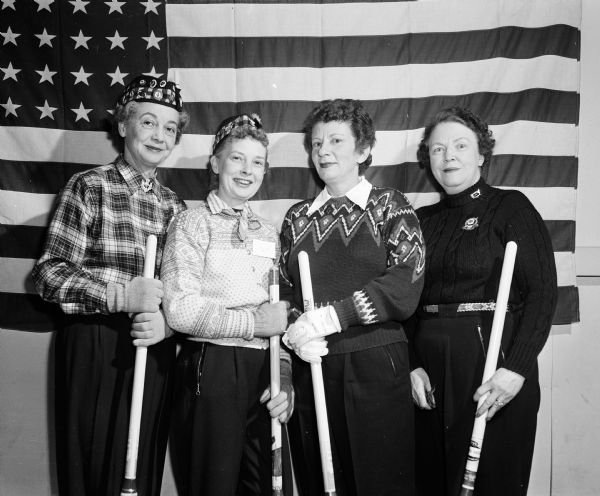 Group portrait of Madison Curling Club's Jamieson Rink at the United States Women's Curling Association bonspiel. Left to right: Madeline Hefty, Edith Resan, Elynore Wegner, Myrtle Jamieson.