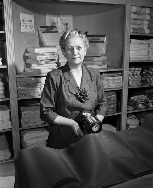 Penney's saleswoman Cora Stern measures fabric at the Madison store. She was named the top saleswoman in the entire Penney's organization.