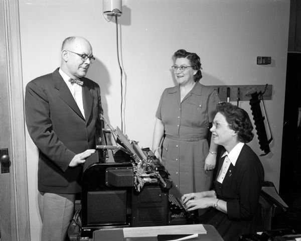 D.F. Farmer of Hyland-Hall Company is shown with Jennie Last (center) and Gertrude Berray (right), both of whom were hired by the firm through placement by the Woman's Service Exchange.