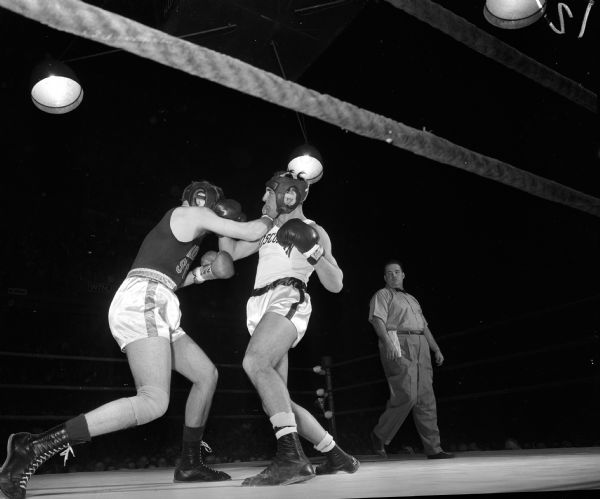 Wisconsin's Bobby Hines (right) lands a right hand punch to the jaw of his Idaho State foe Mike McMurtry during their bout at the University of Wisconsin-Madison Field House.