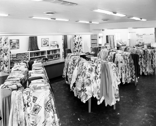 Slightly elevated interior view of fabric displays for draperies and slipcovers at Hendrickson's Modern Home Furnishing Store.