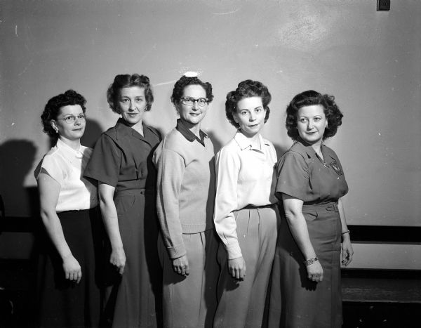 Group portrait of Madison Woman's Bowling Association 1954 tournament's all-event champions in 5 classes. The women are probably Martha Hoffman, June Hanson, Mary Cefalu, Ruth Bollig, and Marvel Risberg.