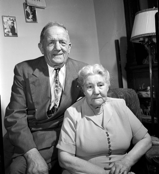 Portrait of Rognald and Anna Larson noting their 50th wedding anniversary. The couple married in the Vinje church in Voss, Norway in 1904 and came to Madison in 1916.
