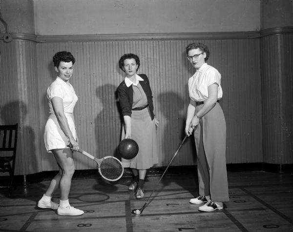 Group portrait of three women posing in athletic clothing with sports equipment in hand. They are, from left, Ruth Ward holding a tennis raquet, Ruth Edie preparing to bowl, and Marie Stoltenberg gripping a golf club. The spring classes were held at the YWCA, 122 State Street.