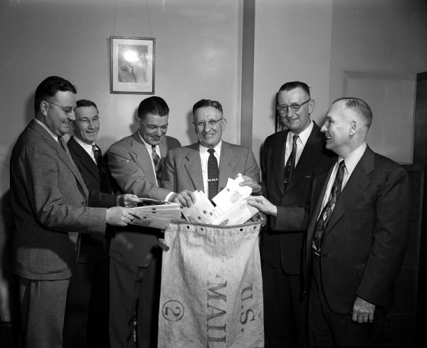 Portrait of the state convention planning committee of the National Association of Postal Supervisors which is planning a convention to be held in Madison. Left to right are Madison postal supervisors LeRoy Murray, Leslie Doyle, Edward Nelson, Elmo Cooper, George Gaukel, and Walter Hahne.