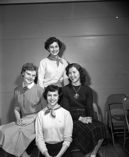 Group portrait of the Madison Advertising Club Essay Contest winners. Cynthia Curreri (first place) is standing and Gretchen Usher, Barbara Nemetz and Bonnie Bishell are seated from left to right.