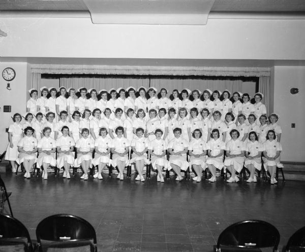 Group portrait of sixty one Madison General Hospital student nurses who have received their nursing caps in a capping ceremony.