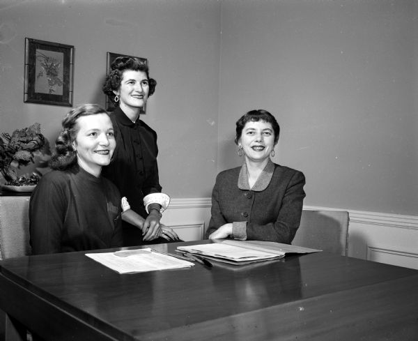 Group portrait of Edythe Lubing (left), Elizabeth Land, and Judith Davis. The women are members of the Dane County Medical Society Women's Auxiliary dinner dance committee.