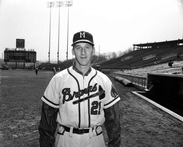 Portrait of Hall of Fame Milwaukee Braves pitcher Warren Spahn in front of the dugout at County Stadium.