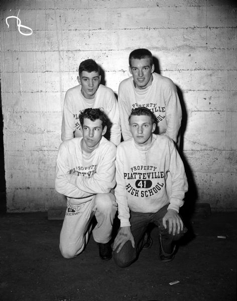 Group portrait of Platteville's sprint medley relay team, first place winners in the Class B division at the 17th annual Madison West Relays. Front row: Larry Baker, Bob Irish. Back row: Jack Gardner, Charles Garvey.
