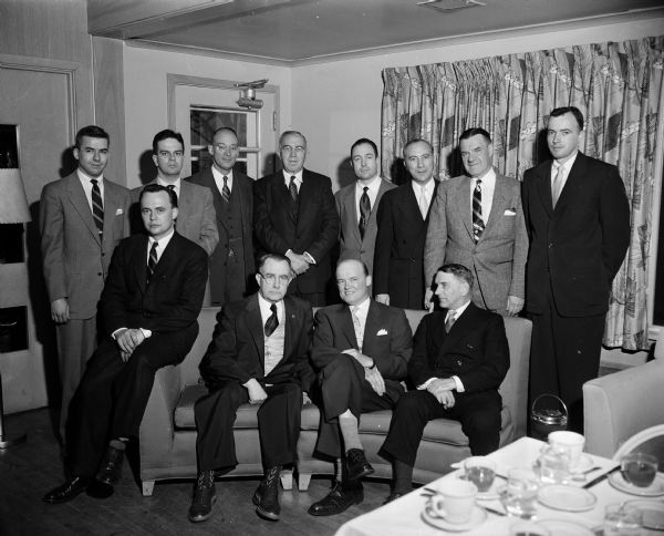 Group portrait of U.W. students who have been initiated into the Phi Alpha Delta legal fraternity. Also shown, seated in the front row, are Circuit Judge Alvin Reis (left) and Justice Timothy Brown, State Supreme Court.