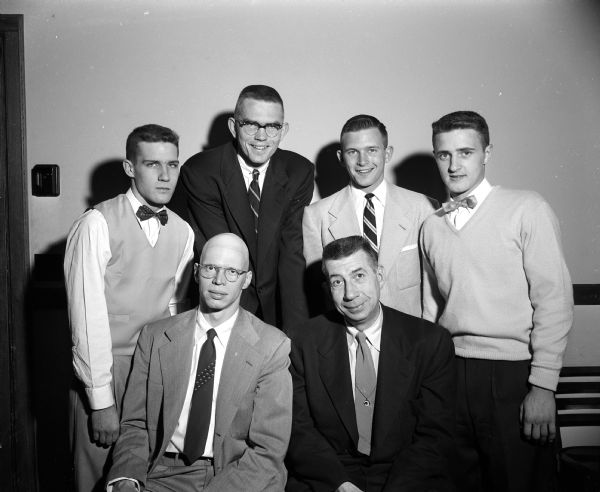 Group portrait of the speakers at West High School's basketball banquet. Seated left to right: Don Page, West HS coach, and Harold (Bud) Foster, UW coach. Standing left to right: Dave Baskerville, John Parker, Tom Mack, Joe Stassi.