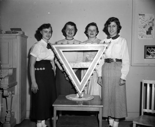 Group portrait of the committee responsible for planning a Y-Teen dance, part of a World's Fair staged by the Y-Teens of Madison. From left are: Virginia Dorr, Judy Bruce, Harriet McDonough, and Sue Parisi.