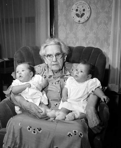 Mrs. Susanna Stumpf, widow of Mr. M.H. Stumpf, 1136 East Dayton Street, celebrated her 88th birthday with her family. She is holding her newest great grandchildren, Donna and Deborah Berggren, four-month-old identical twin daughters of Mr. and Mrs. Donald H. Berggren of Champaign, Illinois. Mrs. Stumpf is the mother of five children: Mrs. Lucille Harks and R.F. Stumpf of Madison; Mrs. Ann Brockel and Lydia MacKenzie of Poynette, and W.P. Stumpf of Arlington Heights, Illinois.