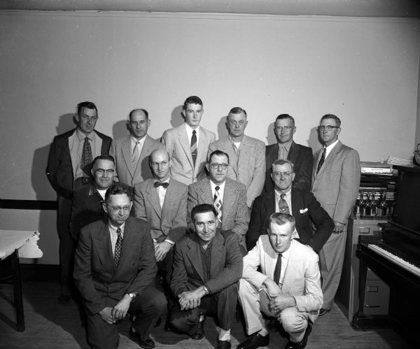 Group portrait of members of the championship Mt. Horeb Rifle Club of the Southwest Wisconsin Rifle League. Front row: Almond Anderson, Black Earth; Claude Standorf, Madison; and Dick Grinde. Second row: Ted Church, Baraboo; Gerald Moen; Russ Pope, Madison; Forrest (Pops) Henderson. Third row: Ray Gentz; Ray Wallace, Madison; Vernon Lunde; Kern Welland, Baraboo; Ken Church, Baraboo; and Melvin Severson.