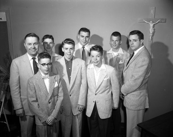 Group portrait of several special guests at the St. Bernard's School athletic banquet among the three-hundred attendees. In the first row, left to right, are basketball players: Jim McCabe, Doug Shackelton, and Joe Blum. In the second row, left to right, are: Carl (Murph) Blum, co-chairman of the event; player Mike McCormick; Wisconsin football player Alan Ameche; player Dave Heisig, and Wisconsin football player Gary Messner.