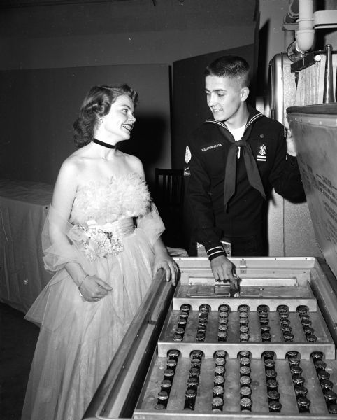 Valarie Thomas and Sea Explorer Ted Cole pause at a soft drink dispenser during the Boy Scout Explorer Ball held at the Army Reserve armory.