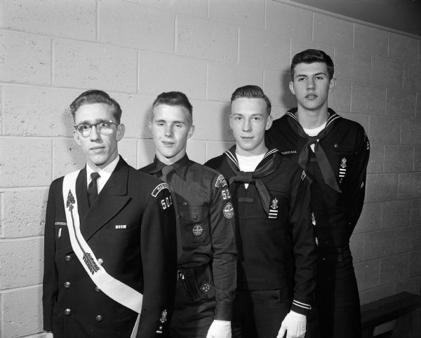 Portrait of four of the scouts who received top awards at the Boy Scout Explorer Ball held at the Army Reserve armory. Left to right are: R.A. Grant, Jon Torgeson, Bill Atkins, and Keith Dehmer.