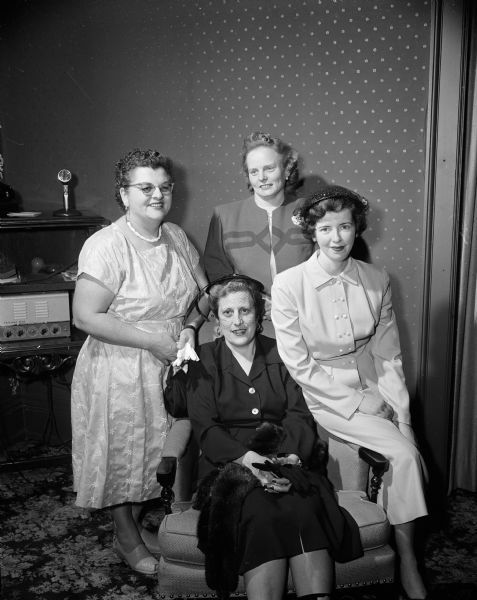 Group portrait of the chairmen of the committees planning Charter Night to honor charter members of the West Side Business Men's Auxiliary. Left: Marie Weidemann. Standing in back: Mrs. Richard Williams. Right: Betty Holley. Center front: Eleanor McMahon.