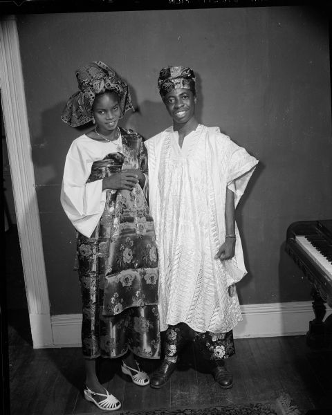 Portrait of Mabel and Ebenezer Iwuagwu of Owerri, Nigeria, dressed in Nigerian garb worn on special occasions. They were reunited after five years apart. Ebenezer Iwuagwu received a BA degree from Long Island University, New York and had been in Madison two years studying for his master's degree in economics.