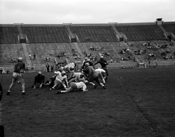 View of a line play during the University of Wisconsin Spring football game.