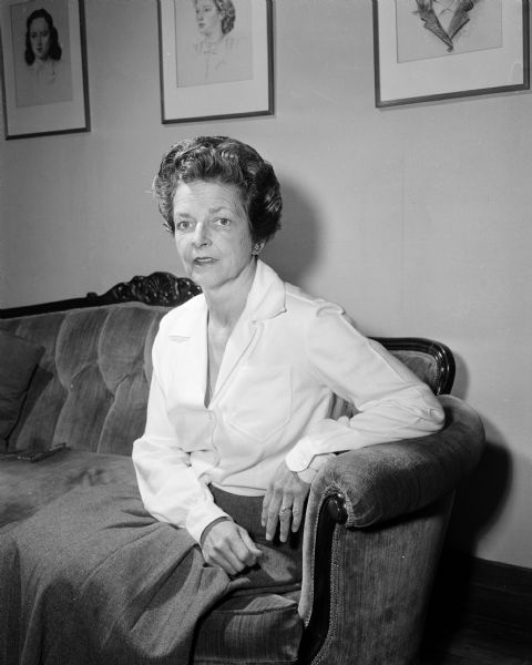 Portrait of Mrs. Holland seated on a sofa.