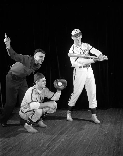 Actors present a University of Wisconsin Medical School junior class skit during Field Day for the medical students. In this skit, television advertising is razzed. The scene is set at a Braves baseball game at Milwaukee County Stadium. The team is doing badly until the batter consumes some of a well-known brand of cereal. The empire is portrayed by Arthur Barrie, the catcher by Robert Wheaton, and the batter by George Crandall.

Field Day is an annual event in which research papers are presented, and various departments have exhibits on their research work, culminating in a banquet and skits by members of the junior class.