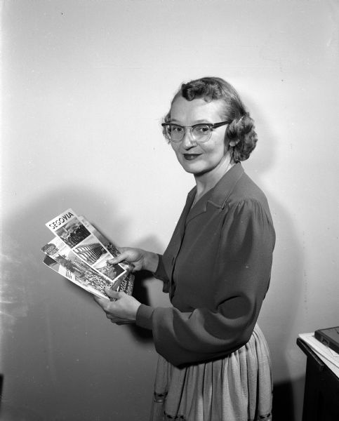 Portrait of Roma Borst, a Spanish-language PhD candidate and a Spanish department teaching assistant. She lead long summer tours of Europe and traveled extensively. She ran and edited the Brooklyn Teller for seven months in 1944 and 1945 from her hometown of Brooklyn, Wisconsin. She had a Saturday morning program on WHA radio called "Musica Latina" and,  when WHA-TV began operations on May 4, 1954, she had a weekly program called "Spanish for Travelers." Borst had a Spanish major and a Journalism minor.