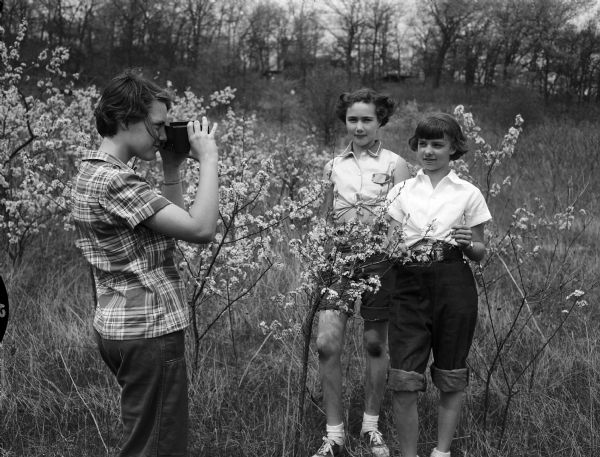 Yvonne Egstad of Middleton takes a picture of two Sauk City fellow campers, Mary Jane Dickerson (left) and Anita Meyer. They were participating in the seventh and eighth grade Girl Scout play day at Camp Brandenburg of the Black Hawk Council.