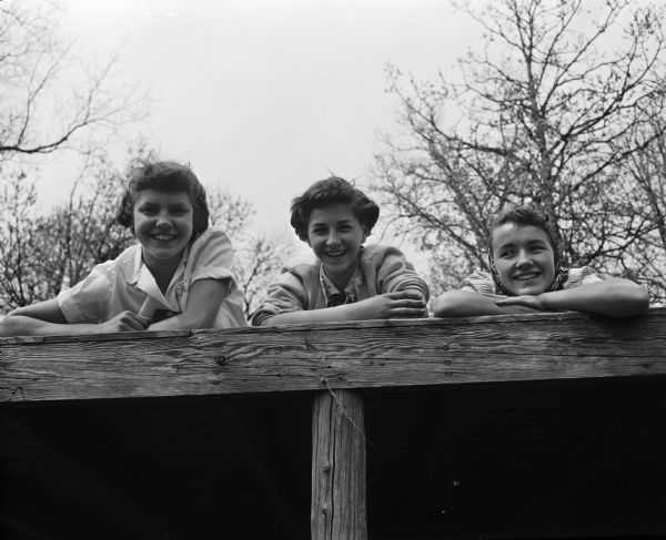 Group portrait of three senior scouts who helped with the younger campers at the seventh and eighth grade play camp at Black Hawk Council's Camp Brandenburg. From left are: Karol Kaufman, Marlene Scheppert, and Karen Abendroth, all from Ft. Atkinson.
