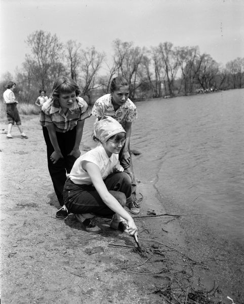 Three campers stand near the lakeshore at the Girl Scouts play day at the Black Hawk Council's Camp Brandenburg. From left are: Judy Wrysinski of Mt. Horeb; Susan Ann Jenswold of Fox Lake; and Suzanne Ramon of Beaver Dam.