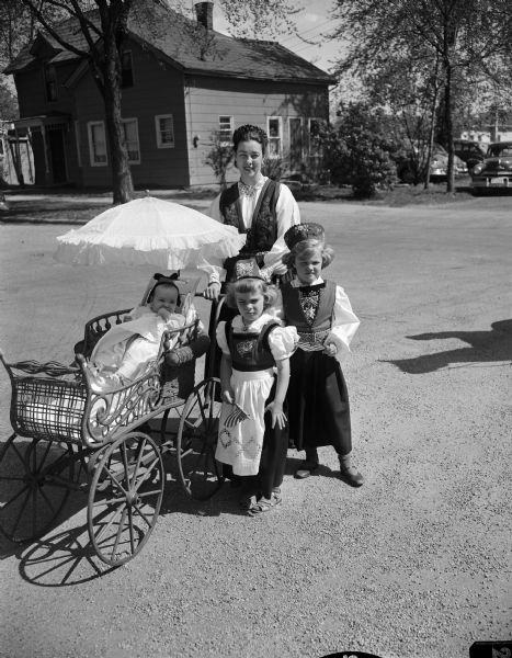Mrs. Walter Eggleson and her three children, Gudron, Jo Ellen, and Sally dressed in Norwegian costumes for the annual Syttende Mai parade in Stoughton.