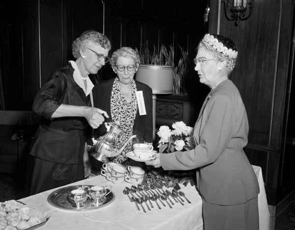 Wives of Zor Shriners are entertained during a coffee hour at Hotel Loraine. Shown left to right: Bertha Lewis of Madison; Mrs. Clifford Brainert, Janesville; Mrs. Laurien Caldwell, Janesville.