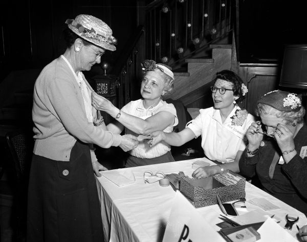 Women take part in a Zor Shrine coffee hour held for wives of members. Standing, left, Flora Millichip, Kansas City, KS. Seated left to right:  Mae Rowley, Ava Pflug, and another unidentified woman.