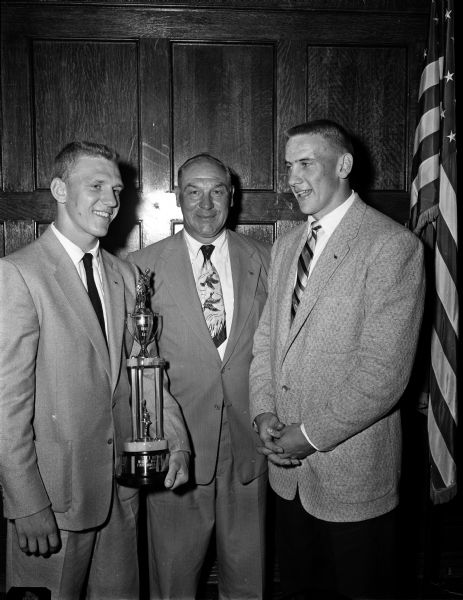 Three men are honored by the Kiwanis Club at the annual luncheon for the University of Wisconsin baseball team. Left to right are: Hal Raether of Lake Mills, most valuable player for the past season; Arthur Mansfield, coach; and Jim Temp, team captain for 1955.