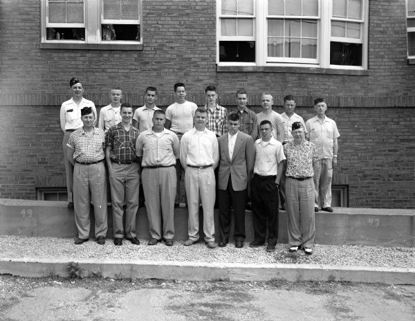 Portrait of the eleven Madison boys being sent to Badger Boys' State at Ripon College by American Legion Post 57. The boys are flanked by Floyd Davidson, Boys' State chairman, and Helmar Lewis, Legion Commander-elect.