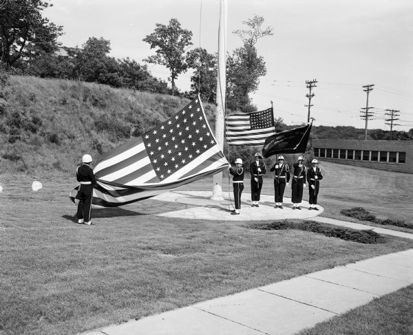 The Belleville American Legion post champion drill team raising the flag during Flag Day ceremonies at the Madison Veterans Administration Hospital.