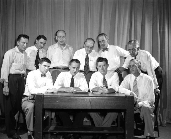 Members of the Madison Shrine and Knights of Columbus met to plan the 11th annual softball benefit and funfest to be held at Breese Stevens Field. Front row, left to right, are: Mack Mitchell, Sherman Geib, Phil Croak, and Lyle Andrews. Back row, left to right, are: Sid Kiefer, Joe Rawley, Ken Svee, Joe Porter, Walt Hendrickson, and Evan Hughes.